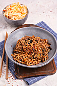 Asian noodles with mushrooms and miso sauce and coleslaw