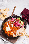 Indian meatballs with naan and cucumber salad