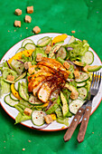 Salad with chicken breast, cucumber, mango and croutons