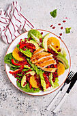 Romaine lettuce with avocado, orange, capsicum and chicken breast