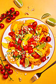 Colourful tomato salad with mango and cashew nuts