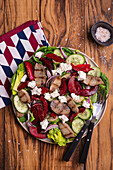 Salad with grilled beef, plums, red onions and cucumber