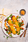 Grilled sweetcorn with peach, satay sauce and feta