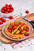 Grilled courgettes and tomatoes on paprika hummus