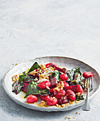 Beetroot gnocchi with walnuts and leafy vegetables