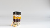 Jar with different coloured pulses and peanuts