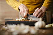 Chop the garlic cloves on a wooden board