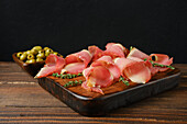 Parma ham with olives and thyme