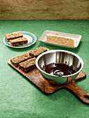 Prepare homemade muesli bars with chocolate coating