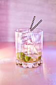 Caipirinha with lime wedges and ice cubes