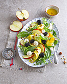 Leaf salad with vegetables, fruit and mozzarella