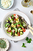 Salad with avocado, tomatoes, lettuce and feta cheese