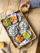 Breakfast with salmon and avocado toast, cucumber and radish salad