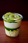 Layered dessert with kiwi and Chantilly in a glass