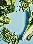 Various green vegetables on a blue background