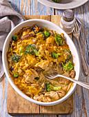 Oven-baked chicken casserole with broccoli and mushrooms