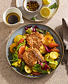 Citrus salad with breaded pork schnitzel and potatoes