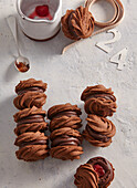 Cocoa sandwich cookies with sour cherry filling