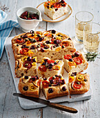 Focaccia with colorful tomatoes, onions and olives