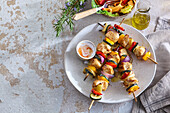 Grilled chicken skewers with vegetables and yoghurt dip