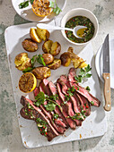 Grilled flank steak with jacket potatoes and chimichurri