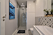 Modern bathroom with patterned tiles and mural