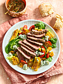 Salad with grilled beef steak, blue cheese and sweetcorn