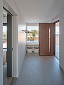 Modern entrance area with window bench and woven storage baskets