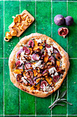 Pumpkin and fig pizza with goat's cheese and nuts