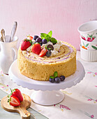 Sponge roll cake with strawberries, grapes and cream filling