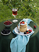 Pancakes with berries and powdered sugar