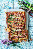 Puff pastry tart with ham and green asparagus