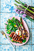 Grilled chicken with bacon-wrapped asparagus and salad