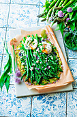 Zucchini pizza with asparagus and wild garlic