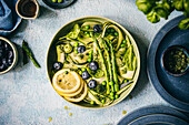 Salad with zucchini, asparagus, cucumber, peas and blueberries