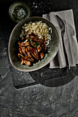 Fried strips of beef steak with long grain rice and herbs