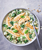 Creamy pesto chicken with gnocchi and pine nuts