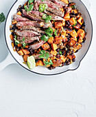 Roast sweet potatoes with beans and beef steak