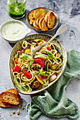 Mediterranean spaghetti with pesto and grilled vegetables