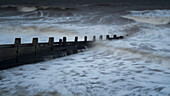 Waves crashing against a groyne