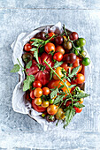 Different types of fresh tomatoes on a plate