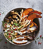 Moroccan chicken bowl with vegetables and pomegranate