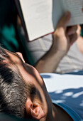 Man Reading Book on Hammock