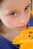 Young Girl Holding Orange Flowers