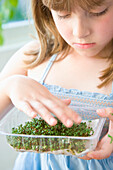 Young Girl Inspecting Watercress Seedlings