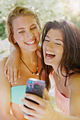 Two Young Women Taking Selfie Laughing