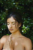 Young Woman Meditating With Hands Together