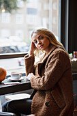 Young Woman Sitting in Cafe