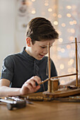 Boy Working on Model Ship