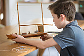 Boy Working on Model Ship